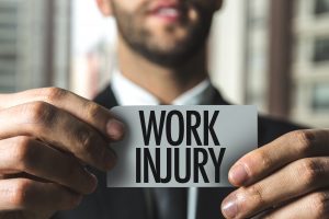 man holding a work injury sign
