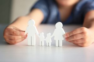 child playing with paper-doll family