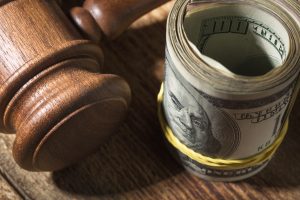 gavel and a roll of money